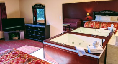 Executive Whirlpool Suite at Grand Marquis Hotel in Wisconsin Dells - main view with a closeup of whirlpool, tv and partial bed view