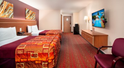 Junior Studio Suite at Grand Marquis Hotel - back view of beds, tv, furniture, microwave and mini fridge