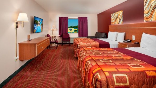 Junior Studio Suite at Grand Marquis Hotel - front view of beds, couch, table and chairs, tv and dresser