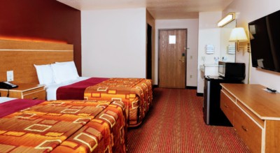 Guest room at Grand Marquis Hotel with 2 queen beds, mini fridge, and HD TV - view when inside the room by the window, towards the entrance