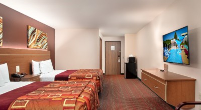 Junior Studio Suite at Grand Marquis Hotel - back view of beds, tv, furniture, microwave, and mini fridge