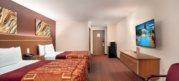 Junior Studio Suite at Grand Marquis Hotel - back view of beds, tv, furniture, microwave, and mini fridge